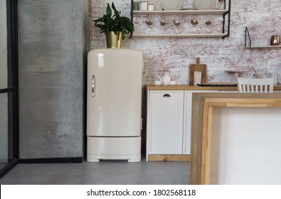 Front view of beige color vintage fridge in loft style kitchen