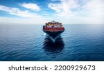 Front view of a big container cargo ship travelling over the ocean with copy space