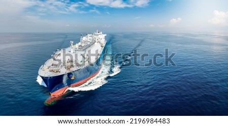Front view of a big LNG tanker ship traveling with full speed over the calm, blue ocean as a concept for international fuel industry with copy space