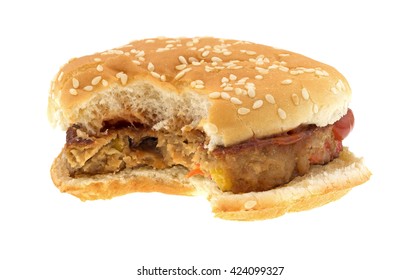 Front View Of A Bitten Veggie Burger On A Bun With Ketchup Isolated On A White Background. 