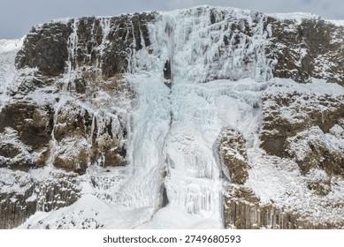 Front View of Bjarnarfoss Waterfall in Deep Winter