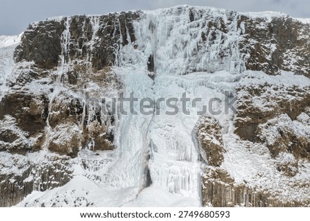 Front View of Bjarnarfoss Waterfall in Deep Winter