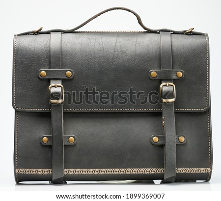 Front view of black leather briefcase isolated on white studio background