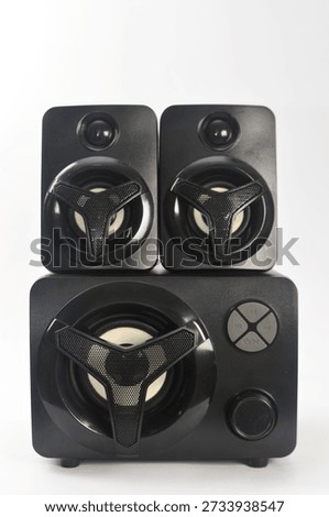 Front view of black multimedia computer speakers with subwoofer on white background