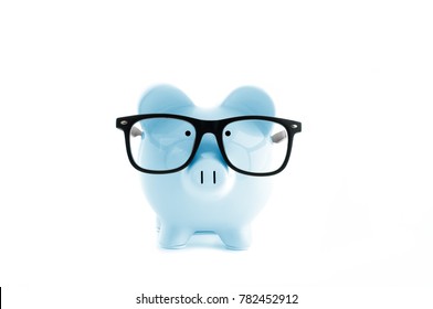 Front view. Blue piggy bank in glasses isolated on white