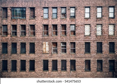 Front View Of A Boarded-up Abandoned Brick Skyscraper Building Windows From The Street In New York City. 
