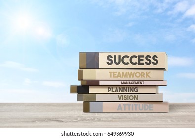 Front View Book Stack of Step to Success Business Concept on Wooden Desk and Sunlight and Bright  Blue Sky  Background, Wording Space.