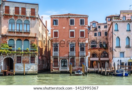 Front view of buildings windows, Venice, Italy. Vintage facades of hotels and residential houses in Venice city center. Scenery of street with historical buildings of Venice, old Italian architecture