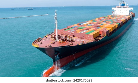front view Cargo Container ship in the ocean ship carrying container and running for import export concept technology freight shipping by ship