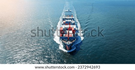  front view Cargo Container ship with contrail in the ocean ship carrying container and running for import export concept technology freight shipping by ship.	