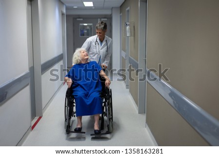 Similar – Doctor talking to elderly patient in a wheelchair