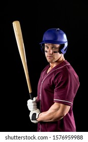 Front View Of A Caucasian Male Baseball Player, A Hitter Wearing A Team Uniform, A Helmet, Stripes Of Eye Black Under His Eyes, And Holding A Baseball Bat. Vertical Shot