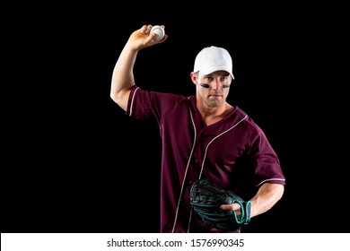 Front View Of A Caucasian Male Baseball Player, A Pitcher Or Fielder, Wearing A Team Uniform, Baseball Cap And A Mitt, About To Throw A Baseball, With Stripes Of Eye Black Under His Eyes