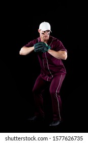 Front View Of A Caucasian Male Baseball Player, A Pitcher Wearing A Team Uniform, Baseball Cap And A Mitt, Preparing To Throw A Pitch, With Stripes Of Eye Black Under His Eyes