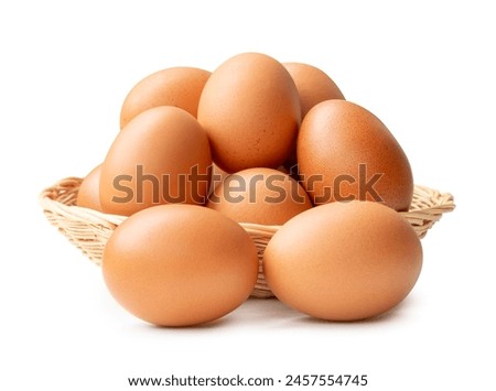 Front view of chicken eggs in stack in wicker basket is isolated on white background with clipping path.