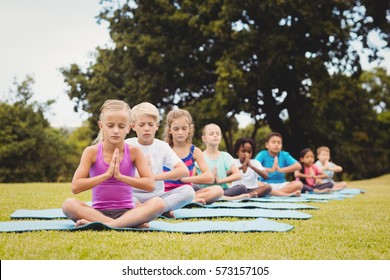 Front View Of Children Doing Yoga In The Park