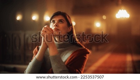 Front View: Christian Woman on her Knees in Front of Altar Starting to Pray in Church. Devoted Parishioner Seeks Guidance From Faith and Spirituality. Religious Believer in the Power of God and Lord