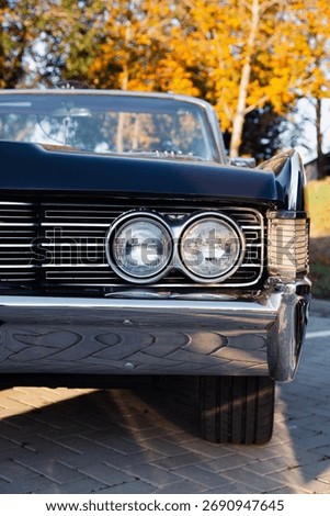 Front view of chrome grille and headlights of vintage 1970s American convertible