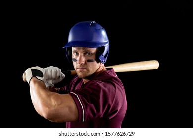 Front View Close Up Of A Caucasian Male Baseball Player, A Hitter, Wearing A Team Uniform And A Helmet, Stripes Of Eye Black Under His Eyes, Ready To Swing A Baseball Bat 