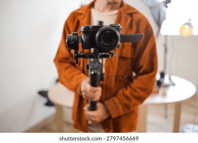 Front View Close up of Mirrorless Camera Mounted on Professional Gimbal Stabilizer Held by Videographer