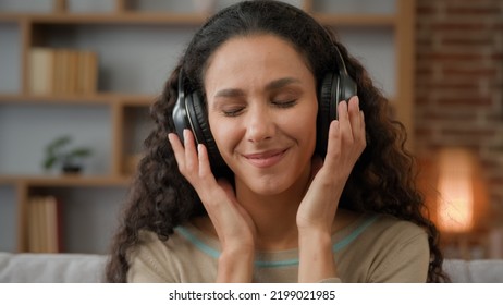 Front view close up smiling Hispanic woman with smiling enjoining lady relaxing at home with closed eyes listening to music in headphones audio sound song feeling well good mood hobby holiday indoors - Shutterstock ID 2199021985