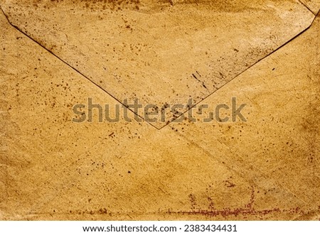 front view closeup of blank old aged closed letter paper envelope with torn edges from 1900
