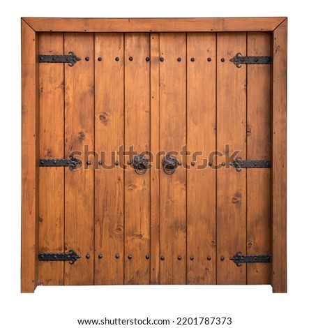 front view closeup of vintage wooden large double barn door with brown wood texture and metallic handle and bolts isolated on white background