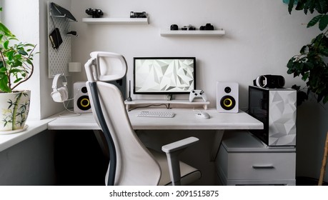 Front view comfortable home office workplace of photographer with computer, camera lens