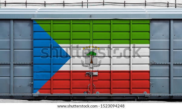 Front view of a container train freight car with a large\
metal lock with the national flag of Equatorial Guinea.The concept\
of export-import,transportation, national delivery of goods and\
rail 