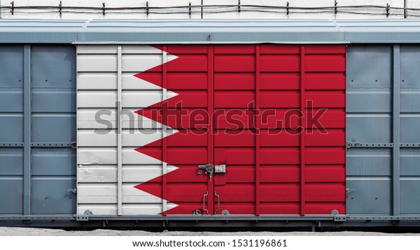 Front view of a container train freight\
car with a large metal lock with the national flag of Bahrain.The\
concept of export-import,transportation, national delivery of goods\
and rail transportation