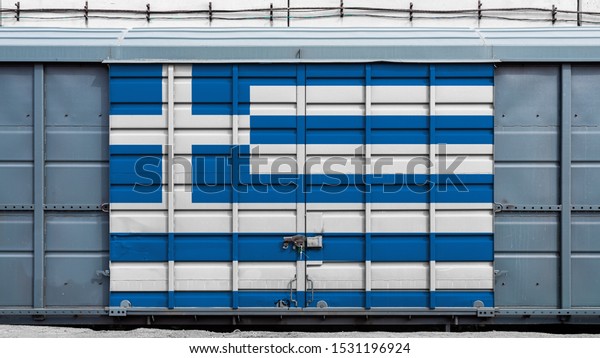 Front view of a container train freight\
car with a large metal lock with the national flag of Greece.The\
concept of export-import,transportation, national delivery of goods\
and rail transportation
