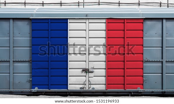 Front view of a container train freight\
car with a large metal lock with the national flag of France.The\
concept of export-import,transportation, national delivery of goods\
and rail transportation