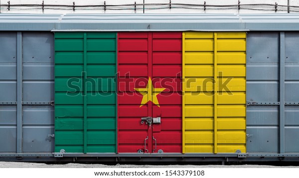 Front view of a container train freight\
car with a large metal lock with the national flag of Cameroon.The\
concept of export-import,transportation, national delivery of goods\
and rail transportation