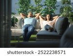 Front view of a couple relaxing on a couch in a terrace