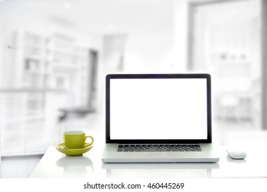  Front View Of Cup And Laptop On Table In Home Office Background