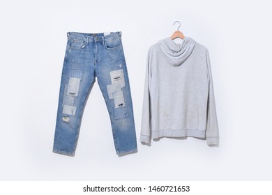 Front View Denim Ripped Blue Jeans And Gray Hoodie Clothes Close-up. –on White Background
