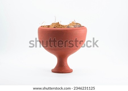 FRONT VIEW OF DHUNUCHI .INDIAN PUJA EQUIPMENT. ISOLATED ON WHITE BACKGROUND WITH GRAINT TONE.