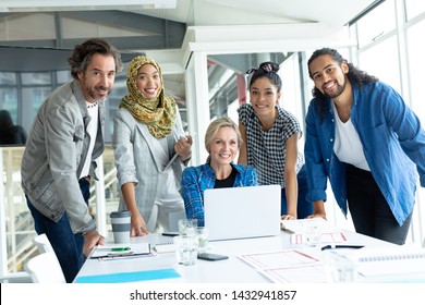 Front View Of Diverse Business People Looking At Camera During Meeting At Conference Room In A Modern Office