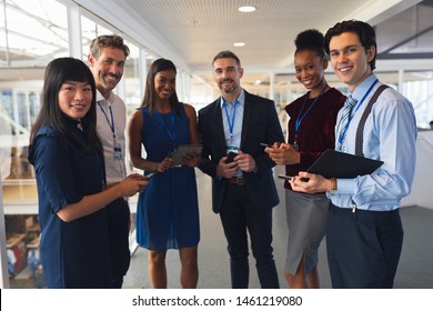 Front view of diverse Business people discussing over digital tablet in a modern office. International diverse corporate business partnership concept - Powered by Shutterstock