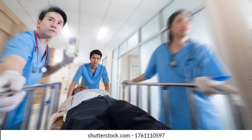 Front view of doctors running to the operating room,Doctor wheeling patient Emergency service hospital background