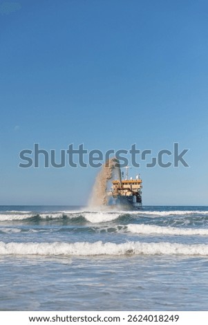 Front view of dredging barge pumping sand off Gold Coast