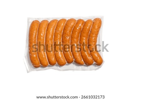 Front view of eight evenly packaged sausages in vacuum film. The sausages are visible isolated against a white background.