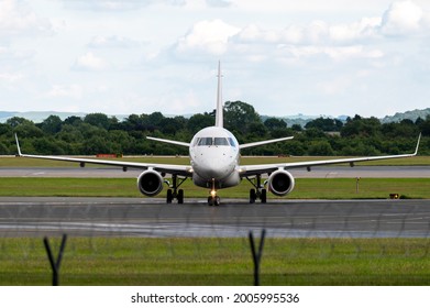 Front View Of An Embraer 170 Turning At The End Of A Runway After Landing