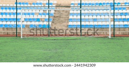 Front view of empty stands and football goal