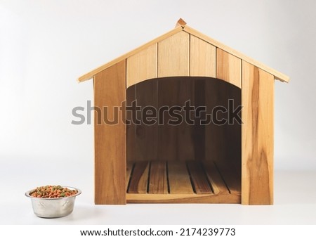 Front view of Empty wooden dog's house with dog food bowl  on white background. Isolated.