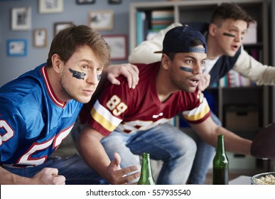 Front View Of Excited Men Watching Sports Game
