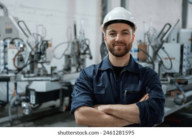 Front view. Factory worker is indoors with hard hat. - Powered by Shutterstock