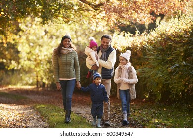 Front View Of Family Enjoying Autumn Walk In Countryside