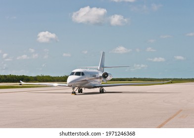 Front View, Far Distance Of A Small, Commercial Twin, Jet, Engine, Plant , Rolling Down Tropical Runway To A Stop