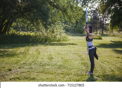 Front View Of Female Archer Training At The Range